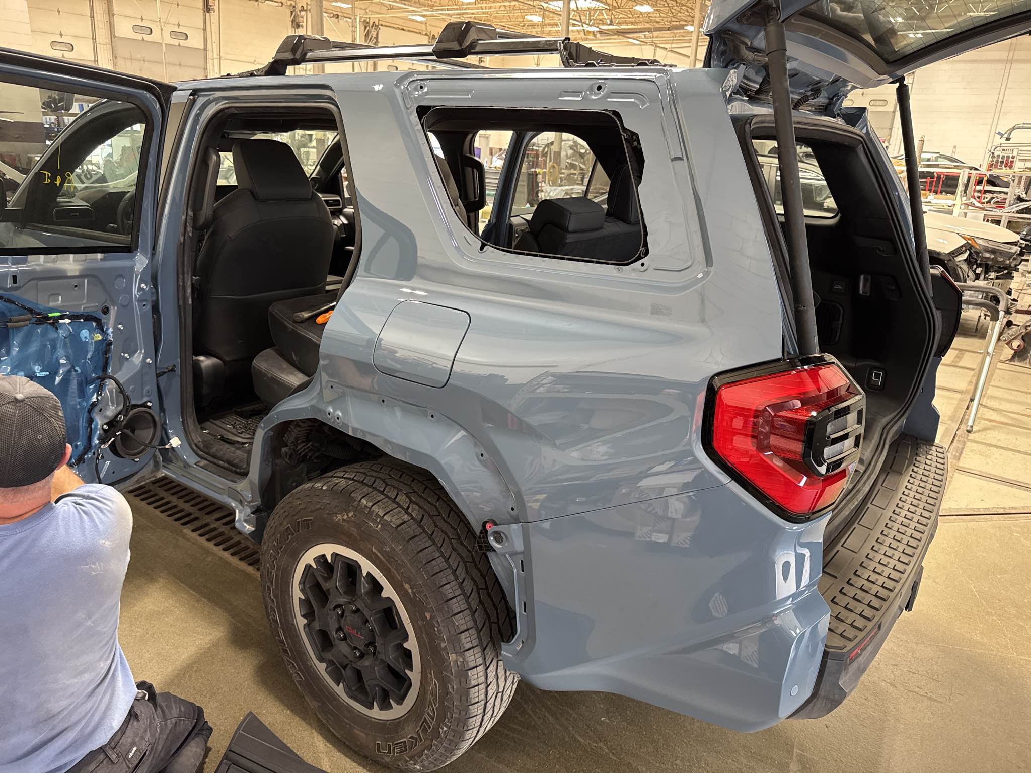 New rear quarter panel being fitted and aligned on a 2025 Toyota 4Runner TRD during collision repair reassembly at Bob Rohrman Collision Repair Center in Lafayette, Indiana