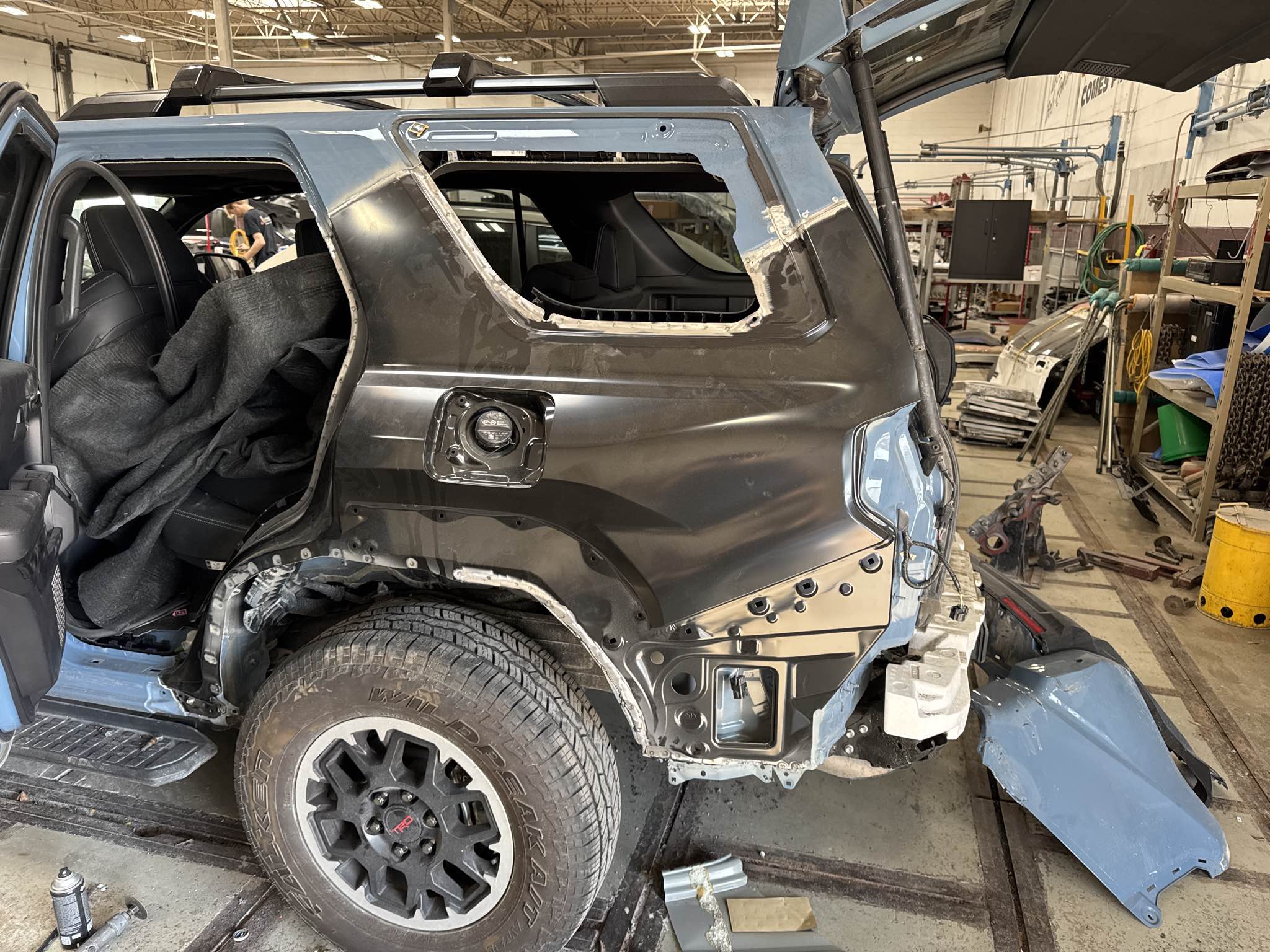 2025 Toyota 4Runner TRD Off-Road with entire rear driver-side section stripped to bare structure during collision repair disassembly at Bob Rohrman Collision Repair Center in Lafayette, Indiana