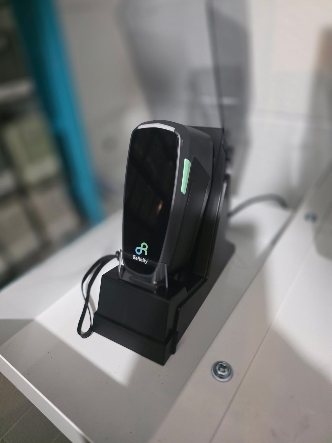 BASF Refinity handheld paint color scanner in its dock in the remodeled paint mixing room at Bob Rohrman Collision Repair Center in Lafayette, Indiana